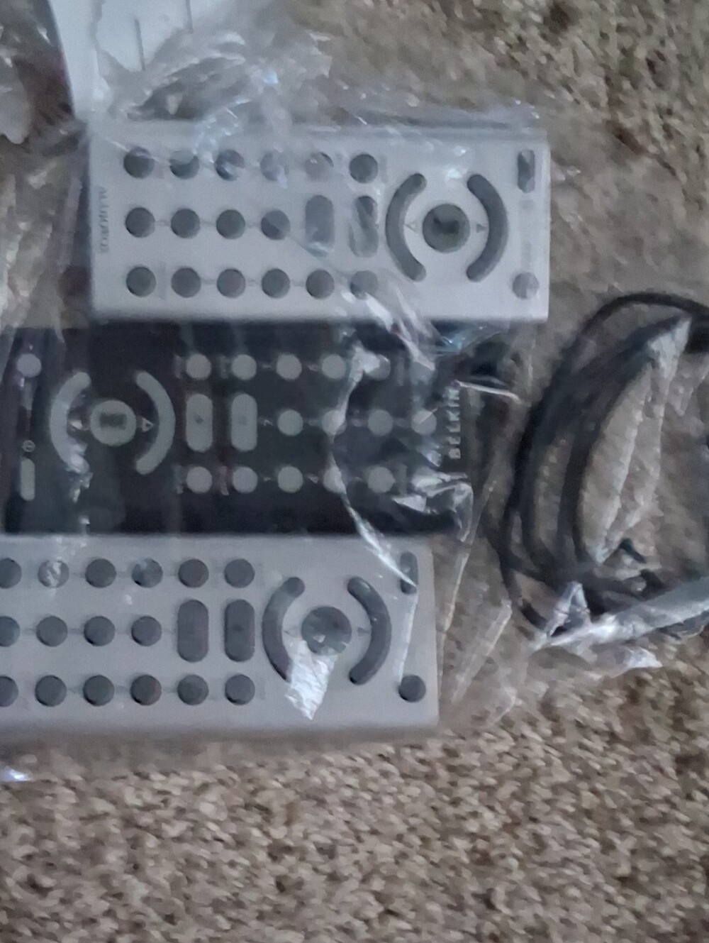 Audiovox+belkin Black and Silver Remote Controls with Cable